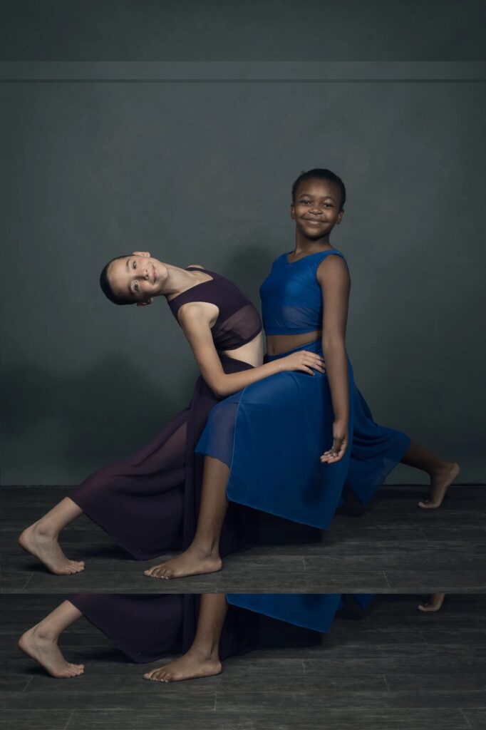 Two smiling girls in contemporary dance pose, showcasing a dance class in Johannesburg.