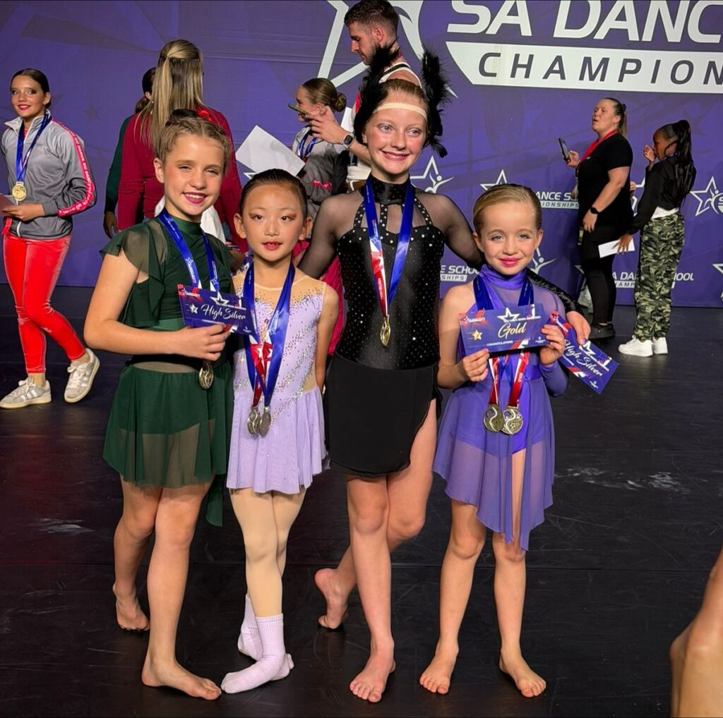 Orlovska dancers showing off their Gold and High Silver medals after performing lyrical, acro, and contemporary solos.