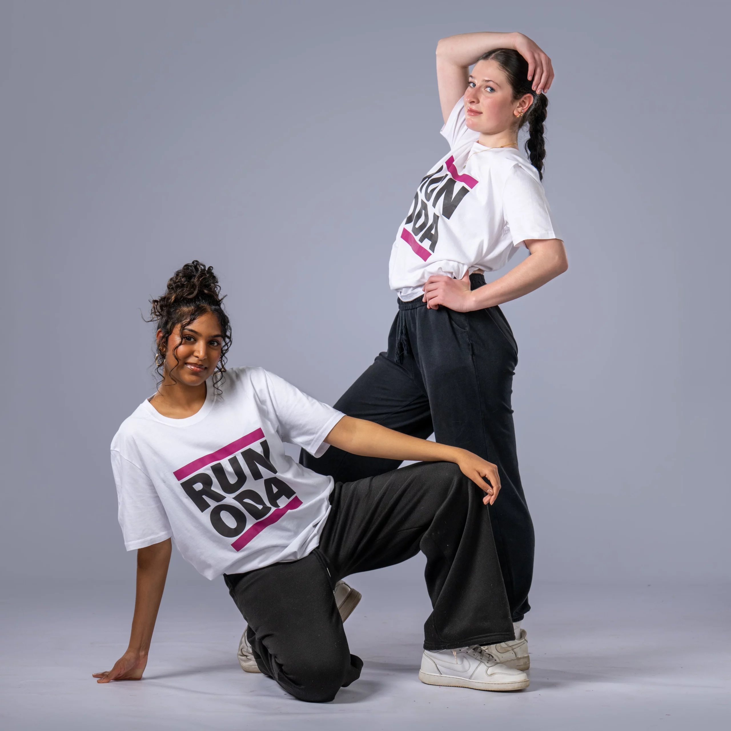 Two female hip hop dancers in branded t-shirts posing confidently, representing senior hip hop classes in Johannesburg.